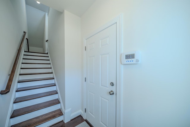 stairs featuring wood-type flooring