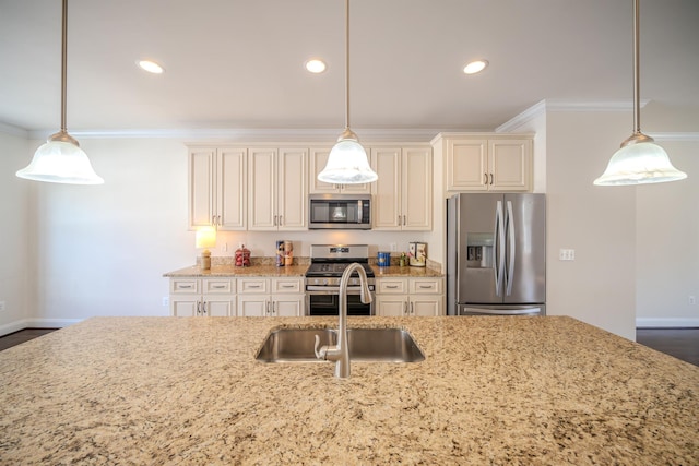 kitchen featuring pendant lighting, sink, crown molding, and appliances with stainless steel finishes