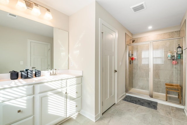 bathroom with walk in shower and vanity