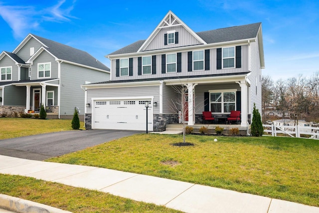 craftsman-style home with a garage, a front yard, and covered porch