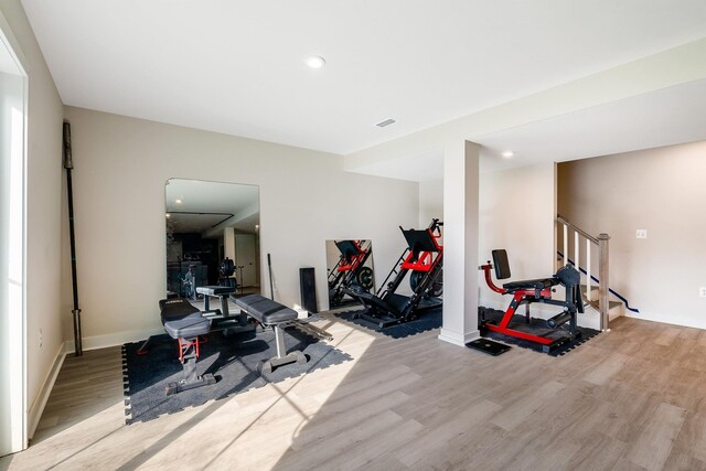 exercise room with light wood-type flooring