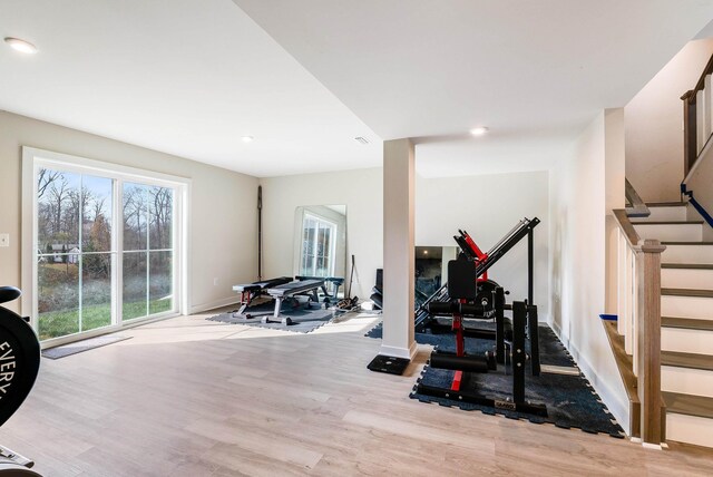 workout area with light hardwood / wood-style floors