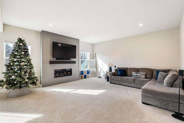 carpeted living room with a large fireplace