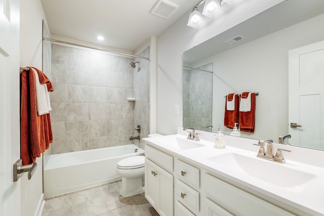 full bathroom featuring vanity, toilet, and tiled shower / bath