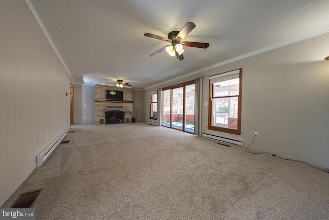 unfurnished living room with carpet floors, baseboard heating, a brick fireplace, and crown molding