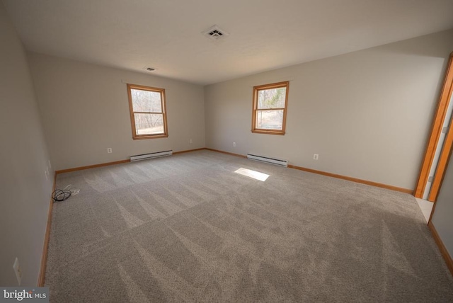 spare room with baseboards, a baseboard radiator, visible vents, and light colored carpet