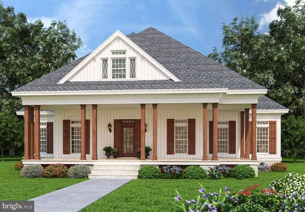 view of front of property with a porch and a front yard