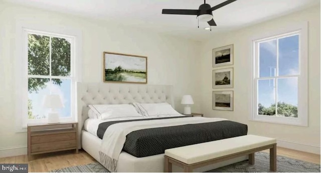 bedroom with baseboards, multiple windows, and light wood finished floors