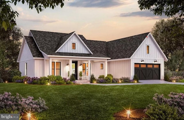 modern inspired farmhouse featuring a garage, a lawn, and covered porch