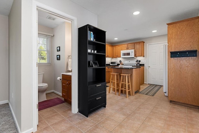 kitchen with light tile patterned flooring, visible vents, recessed lighting, white appliances, and open shelves