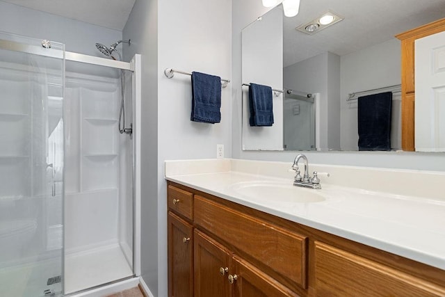bathroom with vanity and a stall shower