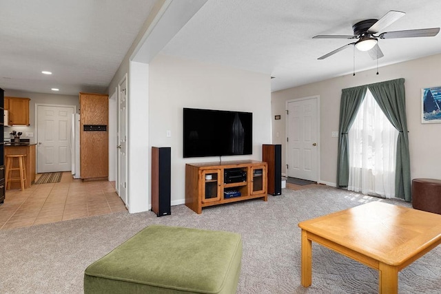 living room with recessed lighting, ceiling fan, baseboards, and light carpet