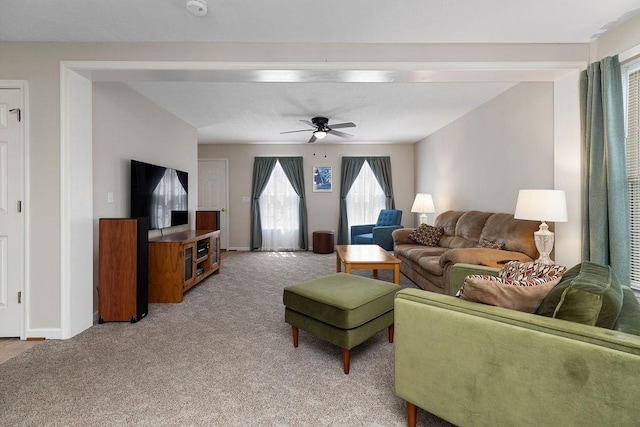 living room featuring light carpet, a ceiling fan, and baseboards