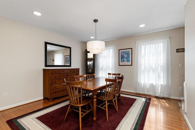 dining room with baseboards, recessed lighting, and light wood-style floors