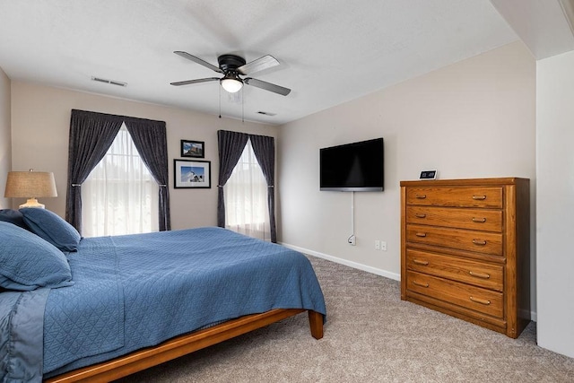 bedroom featuring carpet, visible vents, baseboards, and ceiling fan