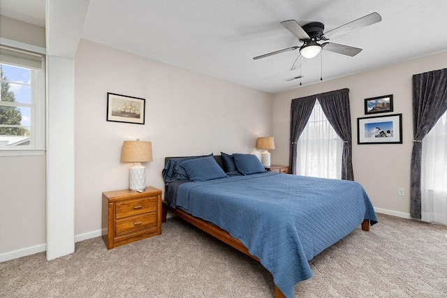 bedroom featuring baseboards, a ceiling fan, and light colored carpet