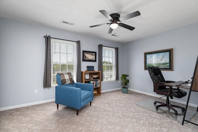 office featuring ceiling fan, visible vents, baseboards, and light carpet
