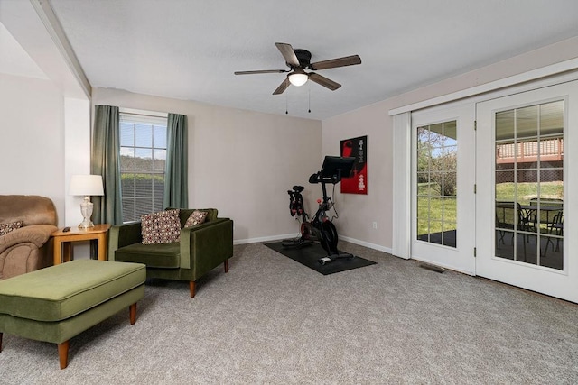 exercise area with ceiling fan, carpet floors, visible vents, and plenty of natural light