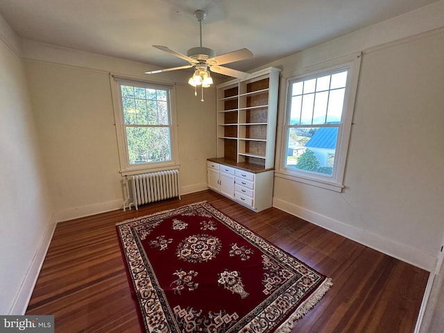 interior space with dark wood finished floors, radiator, and baseboards