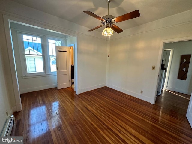 empty room featuring a ceiling fan, baseboards, wood-type flooring, and a baseboard radiator