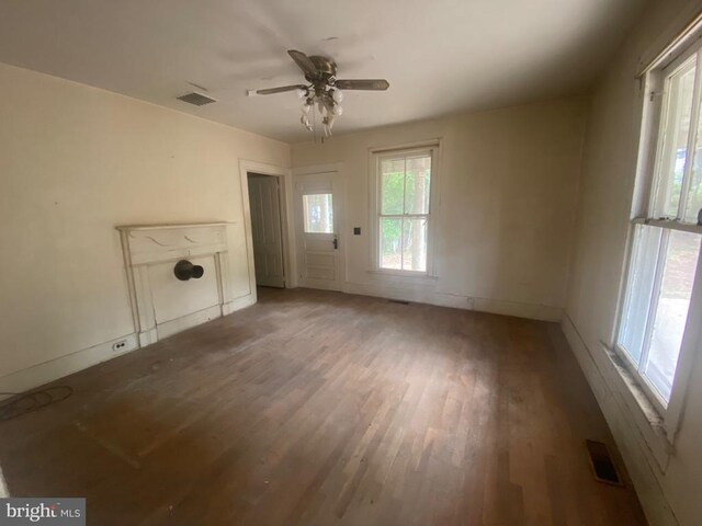 unfurnished living room with hardwood / wood-style floors and ceiling fan