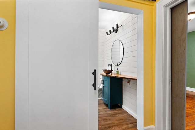 hallway with dark wood-type flooring and baseboards