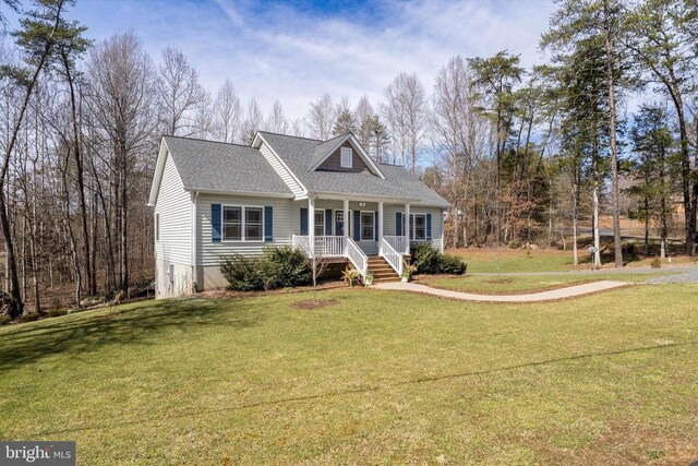 view of front of house with a porch, a shingled roof, and a front yard