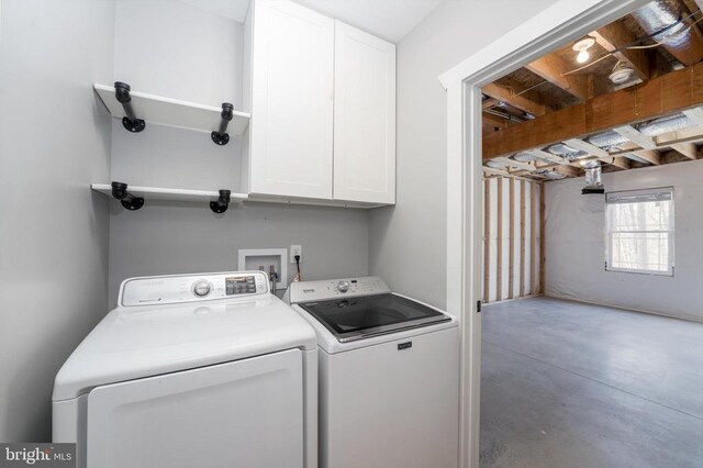 washroom with separate washer and dryer and cabinet space