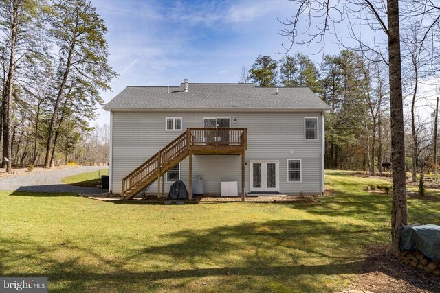 back of property with stairs, a deck, french doors, and a lawn