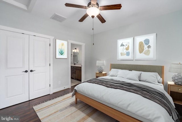 bedroom featuring visible vents, a ceiling fan, ensuite bathroom, wood finished floors, and a closet