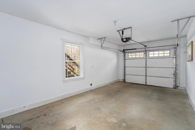 garage featuring a garage door opener and baseboards