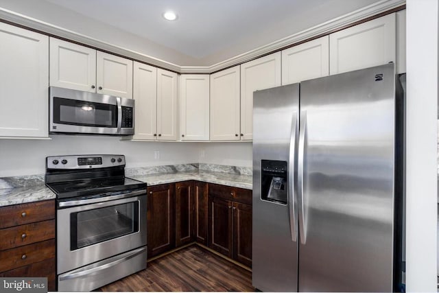 kitchen featuring dark brown cabinets, appliances with stainless steel finishes, white cabinetry, and dark wood-type flooring