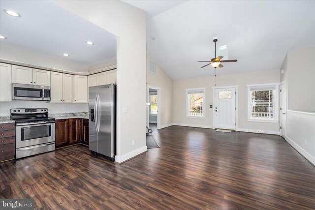 kitchen featuring baseboards, dark wood finished floors, recessed lighting, appliances with stainless steel finishes, and open floor plan