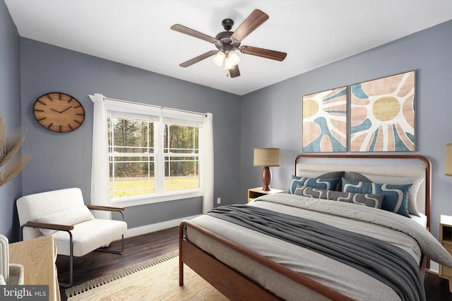 bedroom featuring ceiling fan, baseboards, and wood finished floors