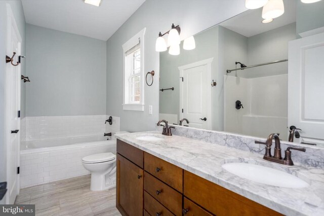 full bath featuring double vanity, a relaxing tiled tub, toilet, and a sink