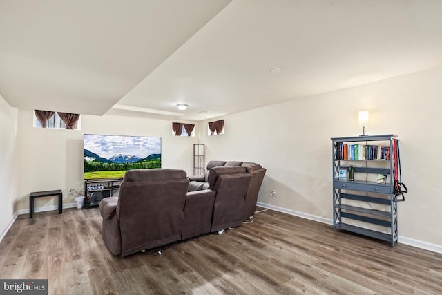 home theater room with baseboards and wood finished floors