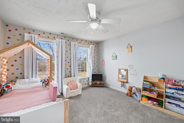 bedroom featuring baseboards, visible vents, ceiling fan, a textured ceiling, and carpet flooring