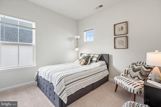 bedroom featuring light carpet