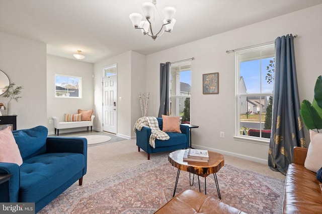 carpeted living room featuring a notable chandelier