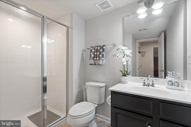 bathroom with a shower with door, vanity, and toilet