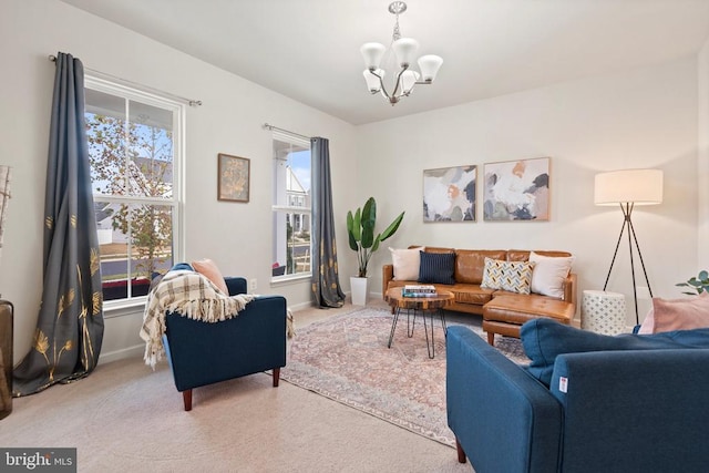 carpeted living room with an inviting chandelier