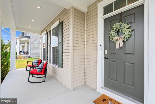 view of exterior entry with a porch