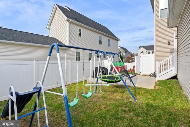 view of playground featuring a patio area, a trampoline, and a lawn