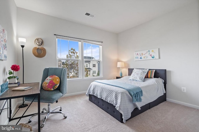 bedroom with light colored carpet