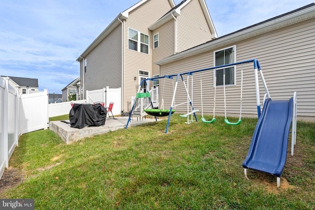 back of house with a playground, a patio, and a lawn