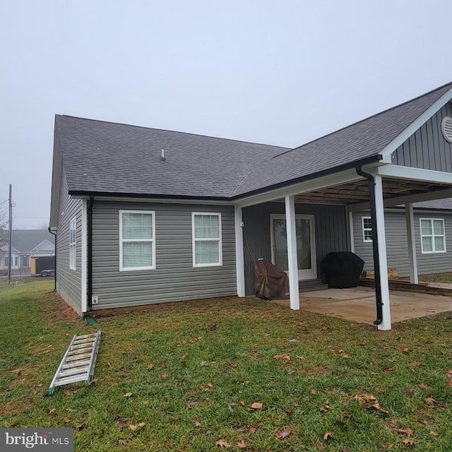 back of property featuring a patio area and a lawn