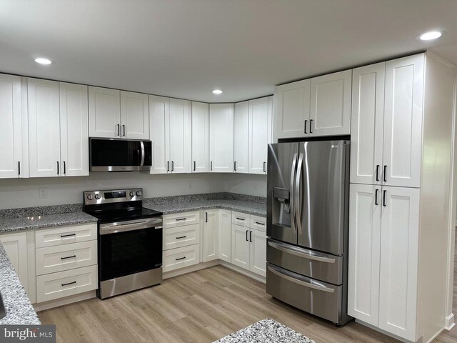 kitchen with stainless steel appliances and white cabinets