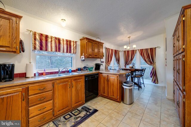 kitchen featuring a peninsula, black dishwasher, a chandelier, brown cabinets, and a sink