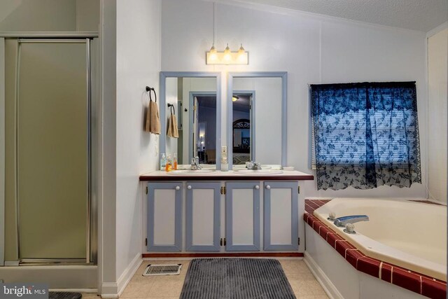 kitchen featuring under cabinet range hood, brown cabinetry, freestanding refrigerator, and electric range oven