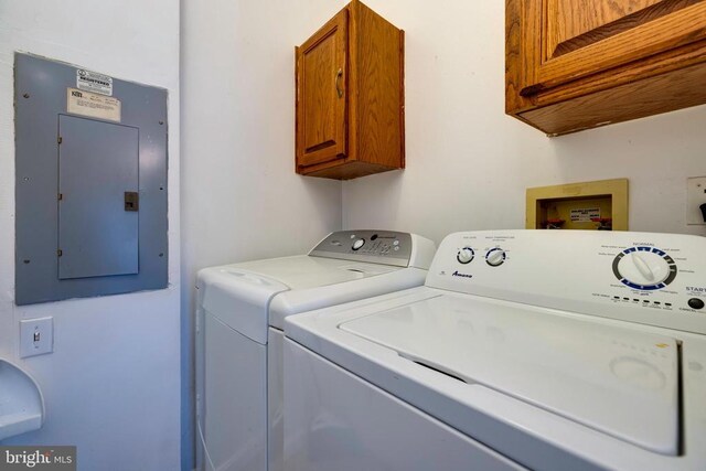kitchen with brown cabinetry, dishwasher, light tile patterned floors, a peninsula, and a notable chandelier